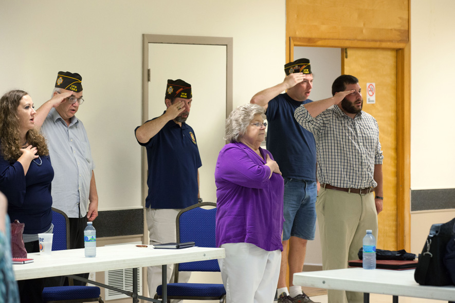 Post and auxiliary members salute the American flag at a recent meeting of Cary VFW Post 7383. “We all have the same desire to work supporting veterans, and volunteering where we can in service and camaraderie,” says Auxiliary Senior Vice President Donna Wright.
