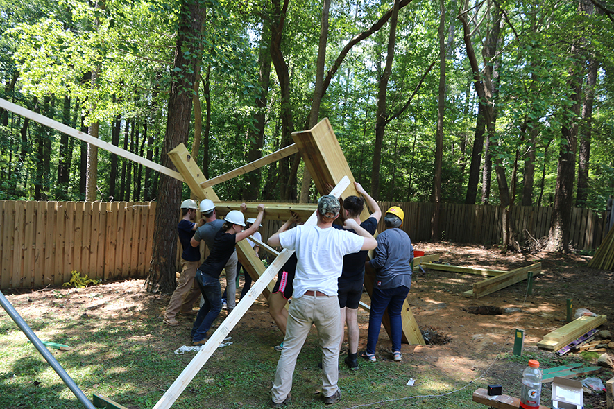 AIAS FBD team members construct an adult-sized play structure for residents of the Living With Autism group home.